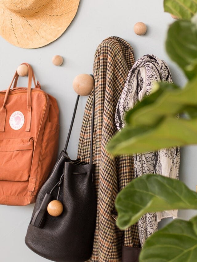 big wood round wall hooks with bags, jackets, and hats