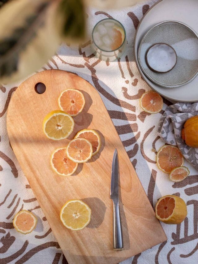 diy wood cutting board with sliced citrus and knife