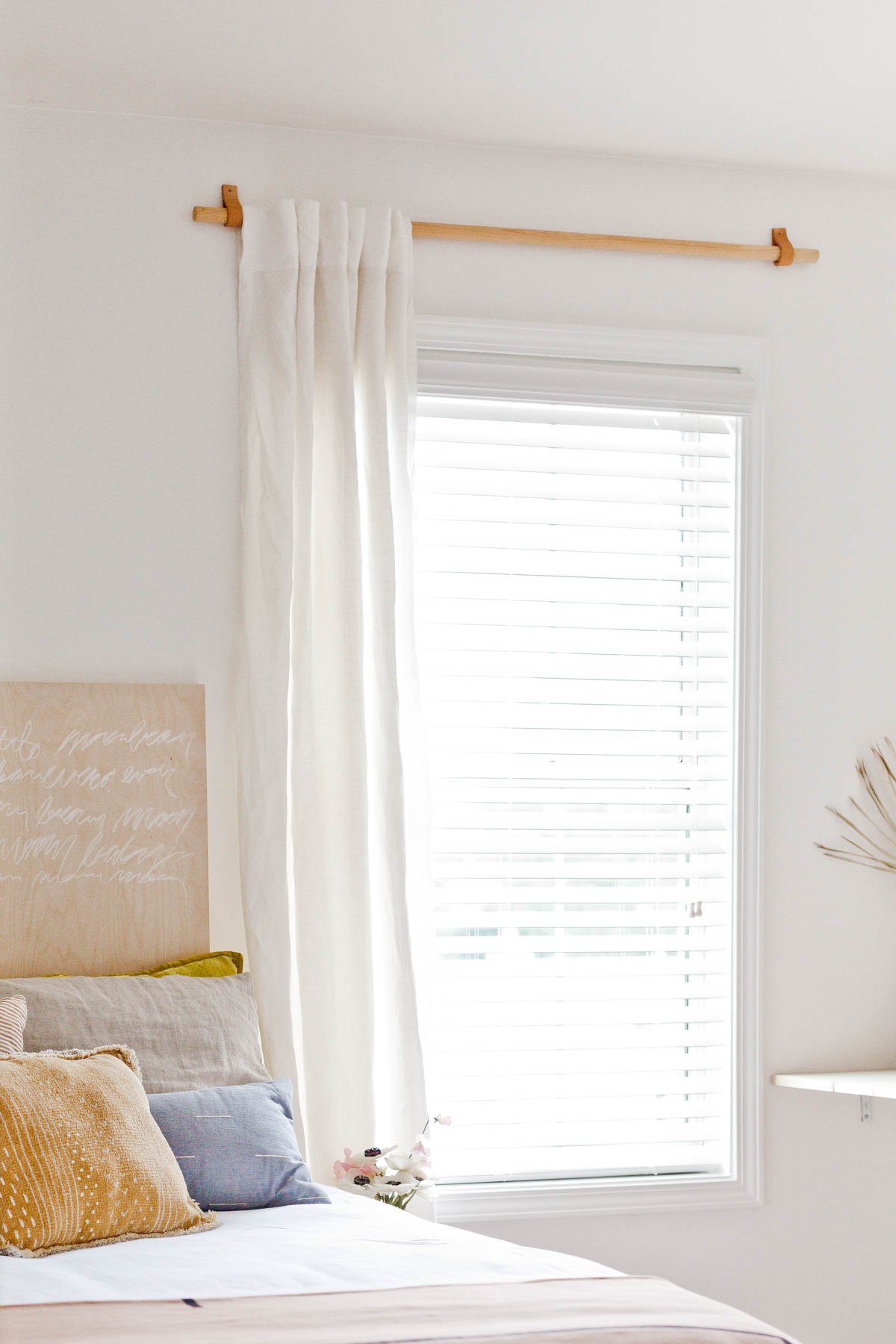 small white bedroom with neutral and pastel details