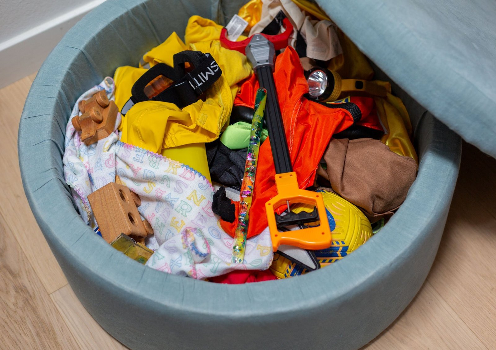 toys in a blue storage ottoman