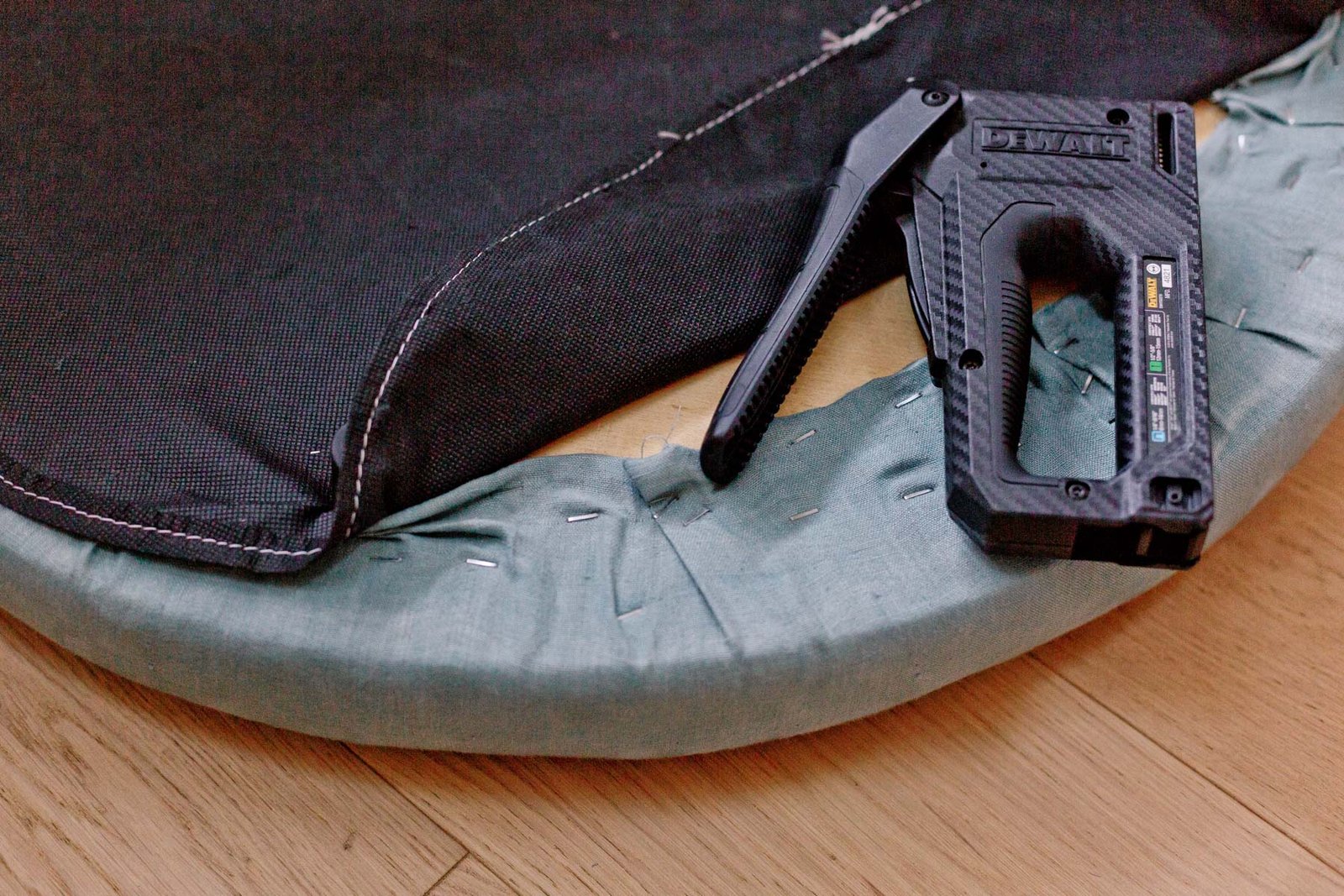 stapling fabric to round ottoman lid