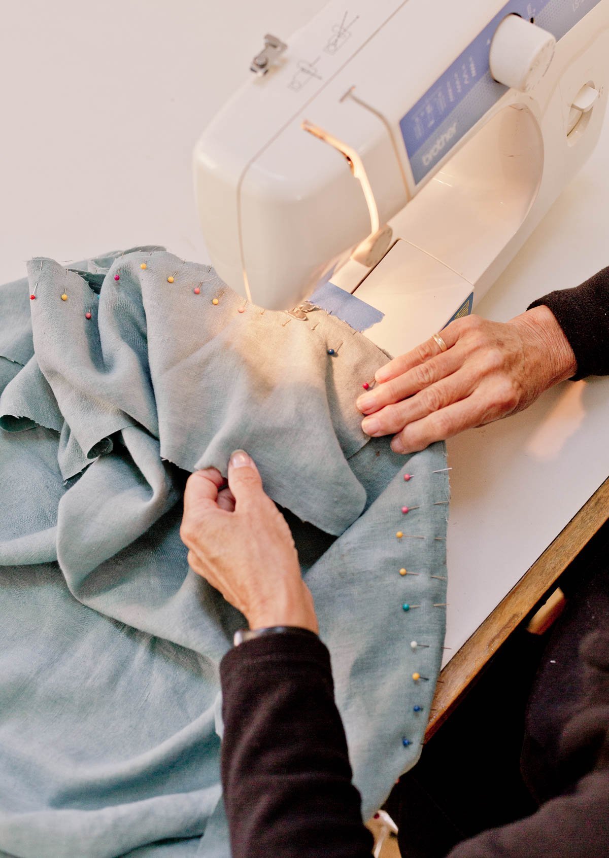 sewing blue fabric with lots of straight pins