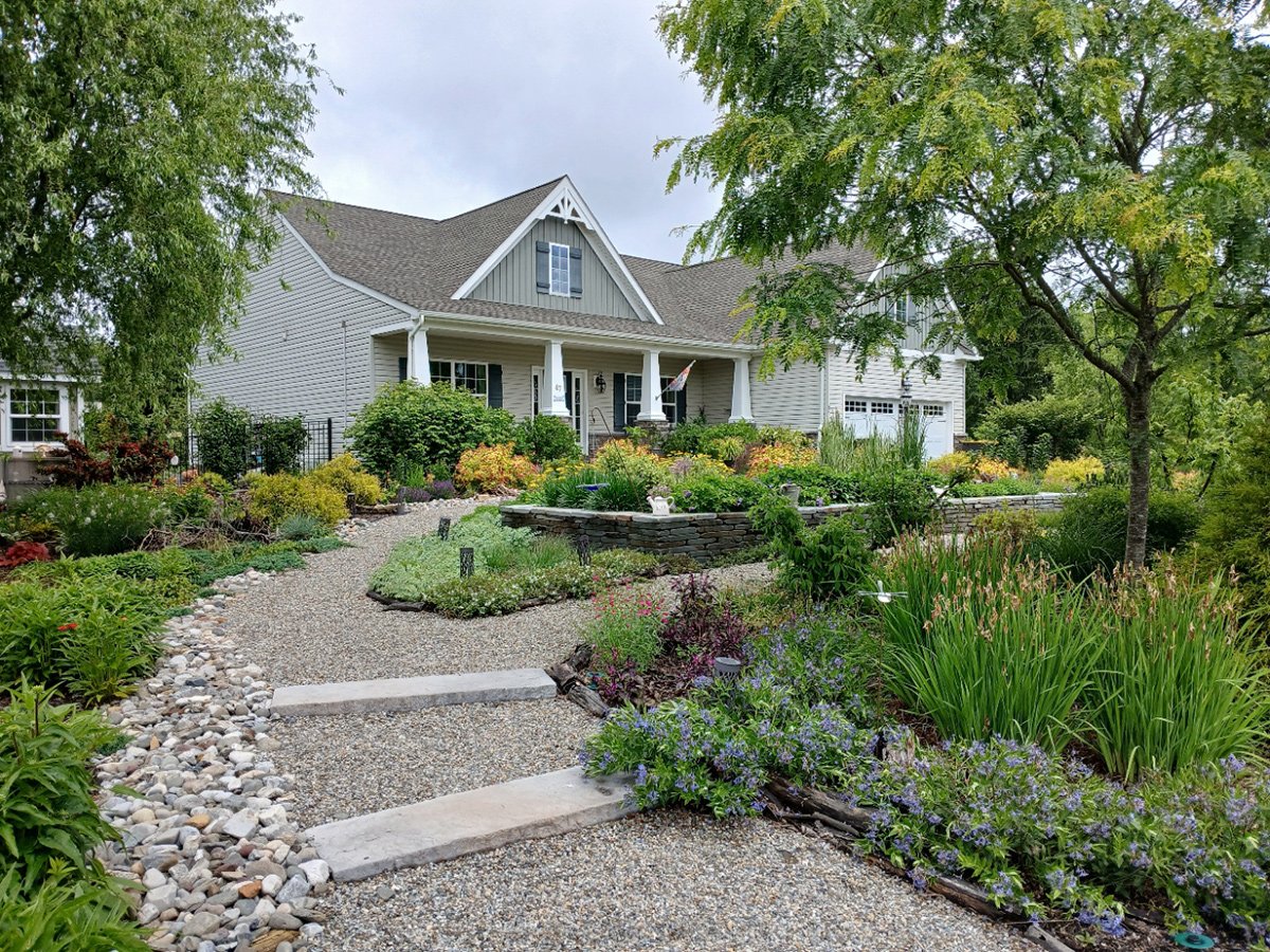 front yard garden with gravel path and large raised bed