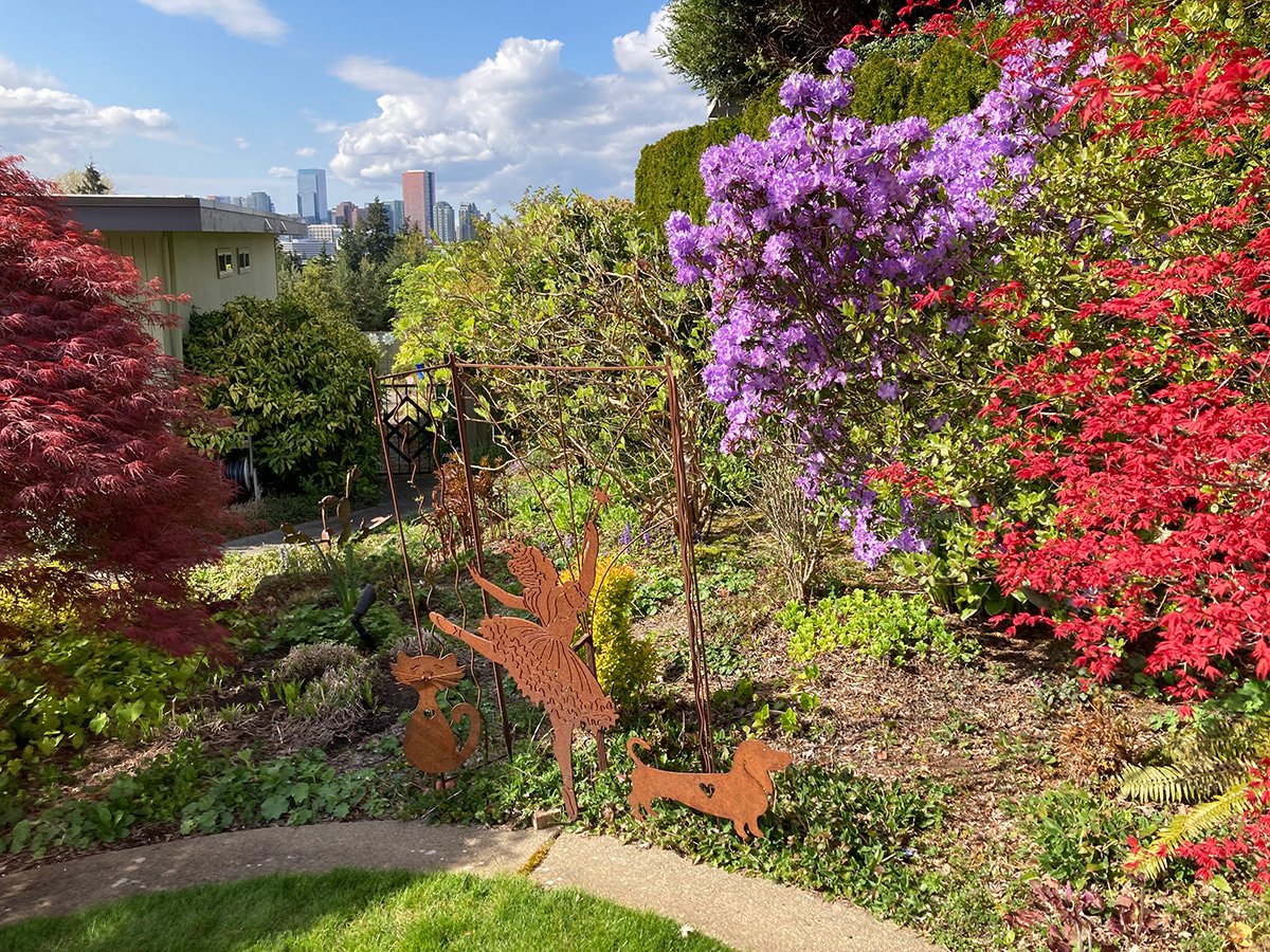 spring garden with purple flowers and red foliage