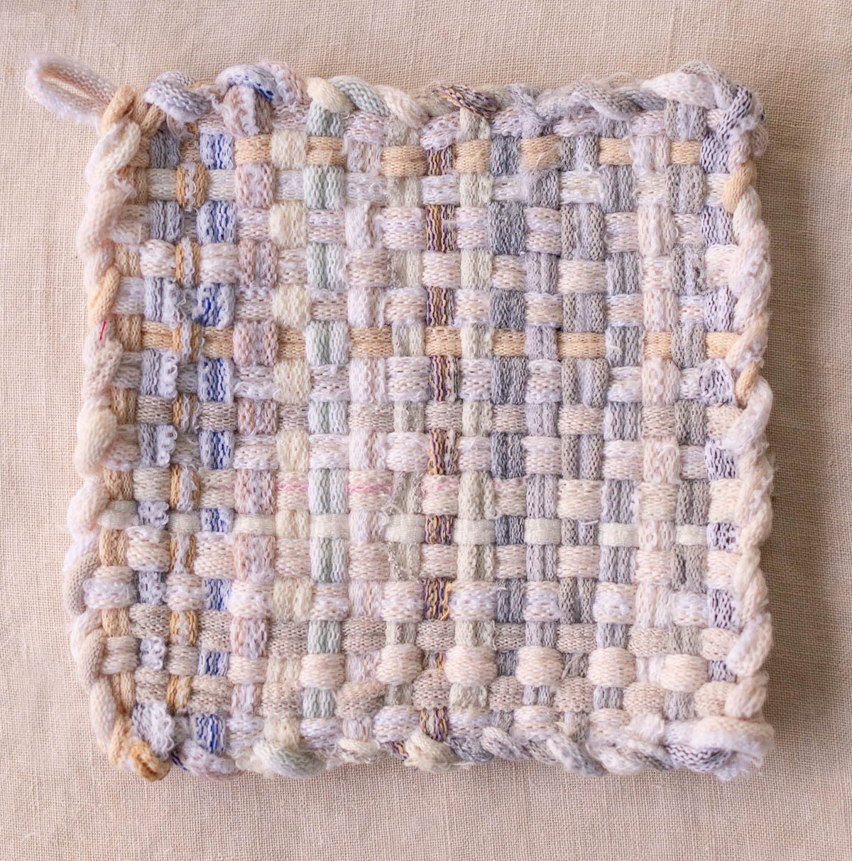 completed potholder in neutral grey and blues